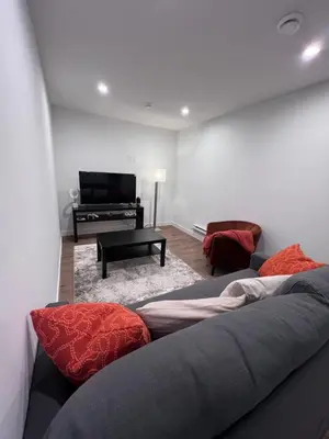 a living room with a couch and a piano at Cozy home away from home in Calgary