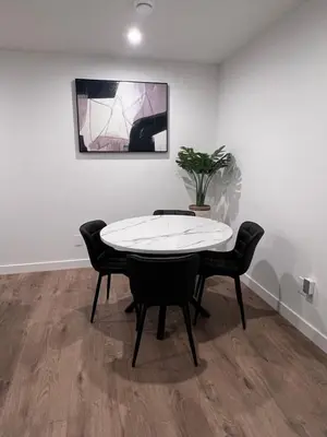 a dining room with a white table and chairs at Cozy home away from home in Calgary