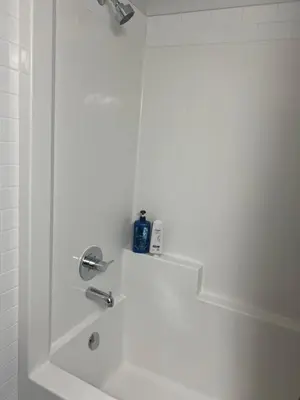 a bathroom with a shower with a sink at Glacier Ridge 1 bedroom haven in Calgary