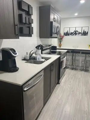 a kitchen with a sink and a dishwasher at Glacier Ridge 1 bedroom haven in Calgary