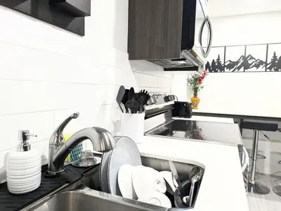 a kitchen counter with a sink and a sink at Glacier Ridge 1 bedroom haven in Calgary