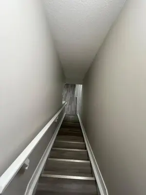 a hallway with stairs in an empty building at Entire 2 Ensuite Bedrooms in a Basement in Edmonton