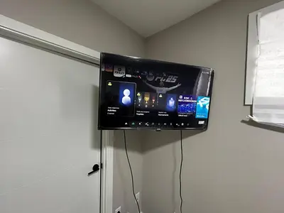 a flat screen tv hanging on a wall at Entire 2 Ensuite Bedrooms in a Basement in Edmonton
