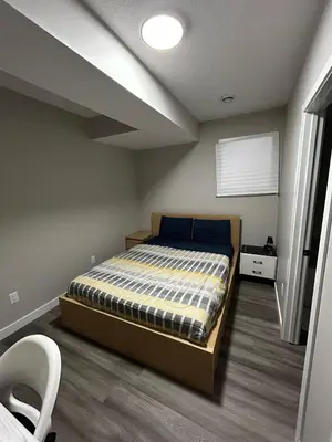 a bedroom with a bed in a room at Entire 2 Ensuite Bedrooms in a Basement in Edmonton