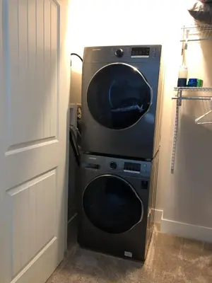 a washer and dryer sitting next to a door at Simcoe B&B - Incredible vacation suite in Smithers