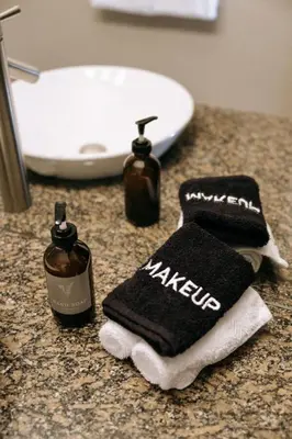 a bathroom counter with two towels and a sink at The Moorage - Luxury 2 bed & 2 bath Condo on Marina in Ucluelet
