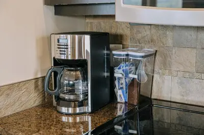 a coffee maker sitting on top of a counter at The Moorage - Luxury 2 bed & 2 bath Condo on Marina in Ucluelet