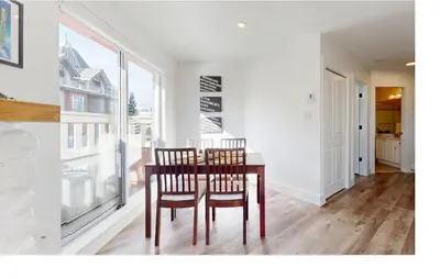 a dining room with a table and chairs and a window at Beautiful 1BR in Village Centre in Whistler
