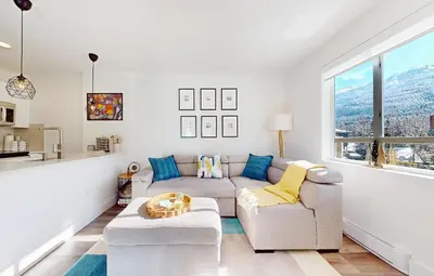 a living room with a couch and a table at Beautiful 1BR in Village Centre in Whistler
