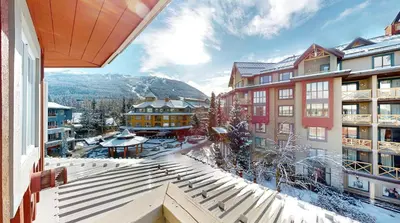 a view from the balcony of a hotel in the snow at Beautiful 1BR in Village Centre in Whistler