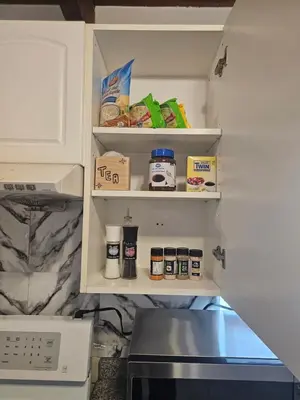 a refrigerator with its door open with food in it at P&N Suites - Queen Room- DUBAI in Edmonton