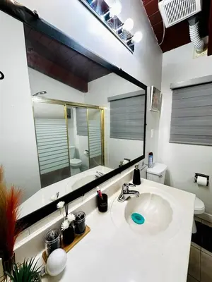 a bathroom with a sink and a large mirror at P&N Suites - Queen Room- DUBAI in Edmonton