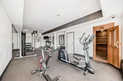 a gym with two treadmills and two exercise bikes at Grande Cache Inn & Suites in Grande Cache