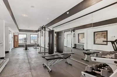 a gym with treadmills and exercise equipment in a room at Grande Cache Inn & Suites in Grande Cache