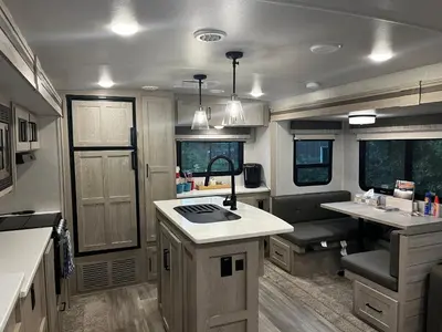 an rv kitchen with a sink and a stove at Luxury Rocky Mountain Glamping in Golden Canada Family Friendly AC Campfire Northern Lights Stargazing in Golden