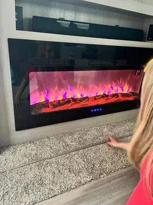 a woman is looking at a fire oven at Luxury Rocky Mountain Glamping in Golden Canada Family Friendly AC Campfire Northern Lights Stargazing in Golden