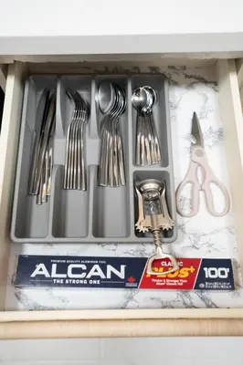 a drawer filled with utensils in a kitchen sink at Modern & Cozy Home in the Heart of Downtown Vancouver in Vancouver