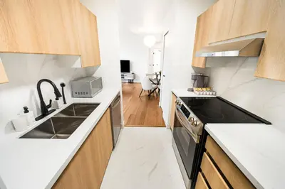 a kitchen with a sink and a stove at Modern & Cozy Home in the Heart of Downtown Vancouver in Vancouver