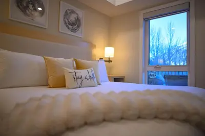 a bedroom with a bed with a pillow on it at 2 bedrooms-3 beds 2 baths-Rocky Creekside Retreat - Top Floor - Heated Pool and Hot Tub in Dead Man's Flats