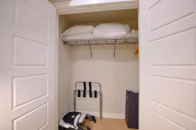 a room with a closet with a bed and a door at 2 bedrooms-3 beds 2 baths-Rocky Creekside Retreat - Top Floor - Heated Pool and Hot Tub in Dead Man's Flats