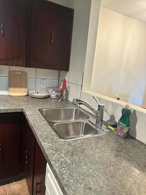 a kitchen with a sink and a counter top at Cozy & bright private one-bed rm in Edmonton