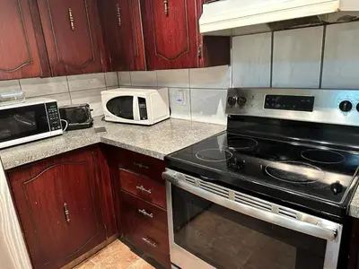 a kitchen with a stove and a microwave at Cozy & bright private one-bed rm in Edmonton