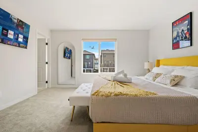 a bedroom with a large bed and a window at 3 Bedroom Detached Home with Free Parking, Netflix, Free Banff Pass, King Size Bed & Portable AC in Balzac