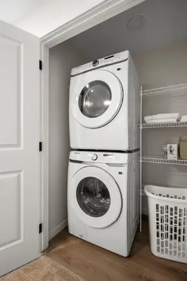 a washer and dryer in a laundry room at Private Lower Suite, Sleeps 4, Queen Bed, Netflix, Parking in Balzac