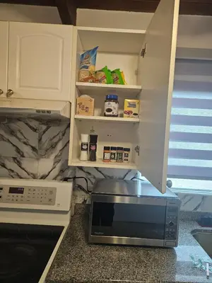 a kitchen with a refrigerator and a microwave at P and N Suites in Edmonton