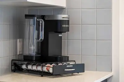 a blender sitting on top of a stove in a kitchen at Skyline Retreat Spacious 4BR Home with Balcony! in Calgary