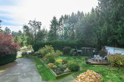 a garden with flowers and plants in a yard at Bayview Bed and Breakfast in Mill Bay