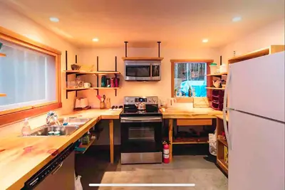 a kitchen with a white refrigerator and a sink at Jordan River Coastal Cottage in Shirley