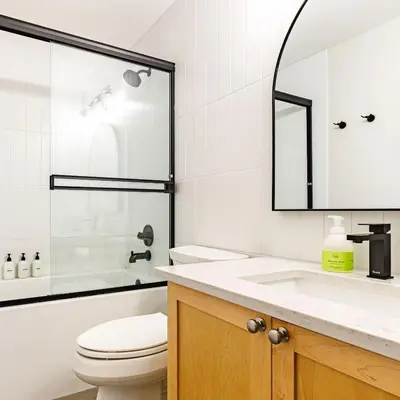 a bathroom with a toilet and a sink and a mirror at Alpine at The Lodges of Canmore in Canmore