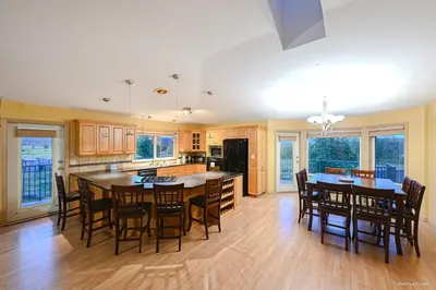 a large kitchen with a large table and chairs at Fort Wine Burrow, Entire Private Estate Home in Maple Ridge District Municipality