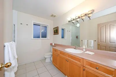 a bathroom with a sink and a toilet and a mirror at Fort Wine Burrow, Entire Private Estate Home in Maple Ridge District Municipality