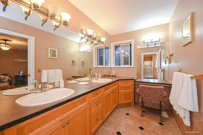 a bathroom with two sinks and a large mirror at Fort Wine Burrow, Entire Private Estate Home in Maple Ridge District Municipality