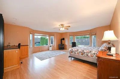 a bedroom with a bed and a ceiling fan at Fort Wine Burrow, Entire Private Estate Home in Maple Ridge District Municipality