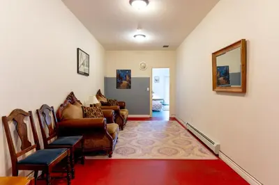 a living room with a couch and chairs and a mirror at Fort Wine Manor, Entire Private Estate Home in Maple Ridge District Municipality