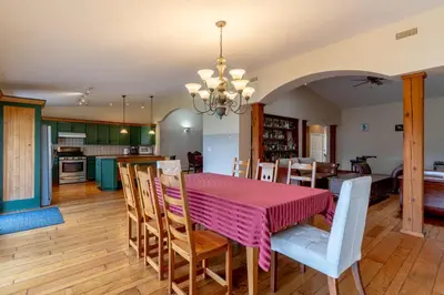 a kitchen and dining room with a pink table and chairs at Fort Wine Manor, Entire Private Estate Home in Maple Ridge District Municipality