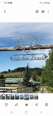 a sign for a hotel with a view of a forest at Quiet Country Cabin in Waiparous Village