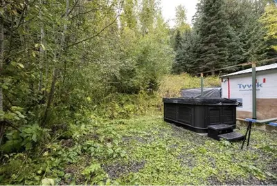 a black dumpster in the middle of a yard at The Marmot's Den in Sun Peaks