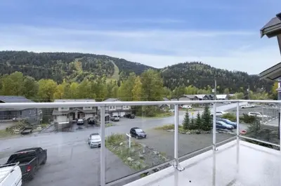 a view of a parking lot with cars parked at The Marmot's Den in Sun Peaks