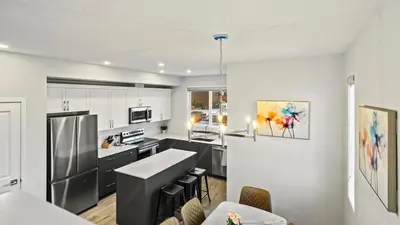 a kitchen with white cabinets and a counter top at A Home away from Home in Calgary