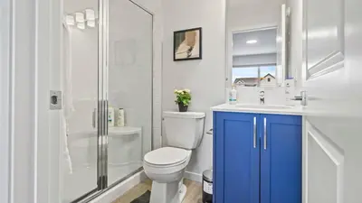 a bathroom with a toilet and a sink and a shower at A Home away from Home in Calgary