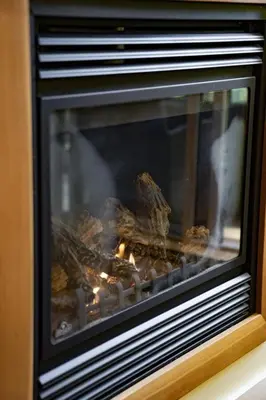 a fireplace with some food cooking in it at Surfers' Nest - Waterfront home in Ucluelet in Ucluelet