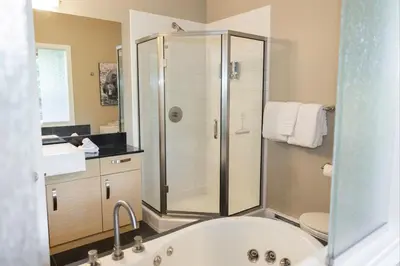 a bathroom with a shower and a bath tub at Surfers' Nest - Waterfront home in Ucluelet in Ucluelet