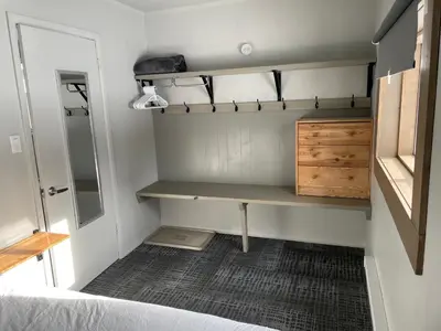 a small room with a desk and a bed at Pinewood Inn in Golden
