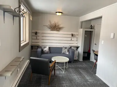 a living room with a blue couch and a table at Pinewood Inn in Golden