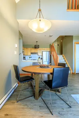 a kitchen and dining room with a table and chairs at Summit at The Lodges of Canmore in Canmore