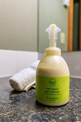 a bottle of the daily cat lotion sitting on a counter at Summit at The Lodges of Canmore in Canmore
